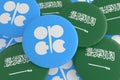 Pile of OPEC Countries Flag Badges: Saudi Arabia And OPEC Flag Buttons, 3d illustration