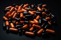 A pile of orange and black pills arranged haphazardly on a white background., Pile of orange-black capsule pills, AI Generated Royalty Free Stock Photo