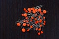 A pile of orange ceramic capacitors on black background