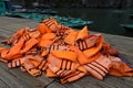 Pile of orange life jackets on a floating dock in ha long bay