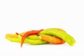 Pile of orange,yellow and green chilli isolated on white background