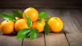 A Pile of Oranges With Green Leaves on a Wooden Table Royalty Free Stock Photo