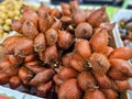 Pile of organic Red salacca wallichiana for sale at the supermarket in Thailand. Royalty Free Stock Photo