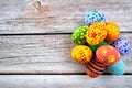 Pile of painted ester eggs in various colors on wooden table. Ester holiday concept