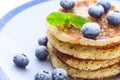 Pile of pancakes with blueberries sprinkled with icing sugar Royalty Free Stock Photo