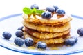 Pile of pancakes with blueberries sprinkled with icing sugar and Royalty Free Stock Photo