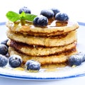 Pile of pancakes with blueberries sprinkled with icing sugar and Royalty Free Stock Photo