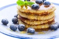 Pile of pancakes with blueberries sprinkled with icing sugar and Royalty Free Stock Photo