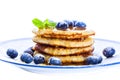 Pile of pancakes with blueberries sprinkled with icing sugar and Royalty Free Stock Photo