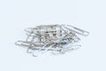 Pile paper clip on white background. Is device used to collect small number of documents together.