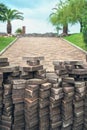 A pile of paving tiles with blurred background of pavement at the park