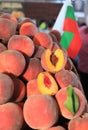 A pile of peaches and one peach, cut in half Royalty Free Stock Photo