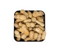 Pile peanuts in a black box isolated on white background. Top view