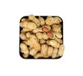 Pile peanuts in a black box isolated on white background. Top view