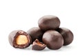 A pile of peanuts in chocolate whole and half on a white. Isolated