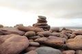 Close up of pile of brown pebbles balanced on top of each other - Beach scene Royalty Free Stock Photo