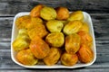 A pile of peeled fresh prickly pear fruit in a plate isolated on wooden background, Opuntia, commonly called prickly pear, Barbary