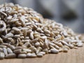 A pile of peeled sunflower seeds on a wooden surface, close-up shot. Seeds without shell Royalty Free Stock Photo