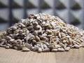 A pile of peeled sunflower seeds on a wooden surface, macro shot Royalty Free Stock Photo