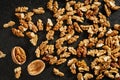 A pile of peeled walnut kernels on a black wooden background. Top view Royalty Free Stock Photo