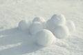 Pile of perfect round snowballs on snow outdoors