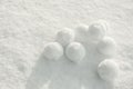 Pile of perfect round snowballs on snow outdoors