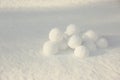 Pile of perfect round snowballs on snow outdoors