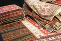 pile of Persian and other rugs for sale in the shop specializing