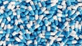 Pile of pills background, pill capsules in white and blue. drug or vitamin capsules