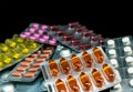 Pile of pills and vitamins in blister packs on dark background with copy space. Medical pharmacy concept Royalty Free Stock Photo