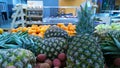 Pile of pineapple, orange and fresh exotic fruit on a supermarket. Blur market background. Ananas. Retail industry. Grocery Royalty Free Stock Photo