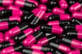 Pile of pink-black capsule pills. Antibiotics resistance. Drug use with reasonable. Global healthcare concept. Antibiotics drug