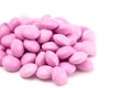 Pile of Pink Candy Coated Chocolate Gems on a White Background