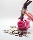a pile of pink pig coins lying on top A hand holding a hammer is pounding a pink pig. The concept of economic depression. Royalty Free Stock Photo