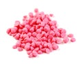 A pile of pink round chocolate isolated on a white background