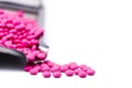 Pile of pink round sugar coated tablets pills on drug tray with copy space. Pills for treatment anti anxiety, antidepressant a