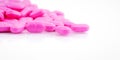 Pile of pink tablets pill isolated on white background. Norfloxacin 400 mg for treatment cystitis. Antibiotics drug resistance. Royalty Free Stock Photo