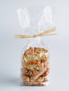 Pile of pistachio Biscotti Cantucci Biscuits Cookies in plastic wrap packaging for sale. Italian dessert cookies close up, Royalty Free Stock Photo