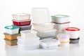 A pile of plastic containers on a white background Royalty Free Stock Photo