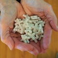 Pile of plastic tile spacers are held in woman`s hands