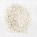 Pile of polished medium-grain rice closeup on gray
