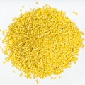 Pile of polished proso millet close up on gray