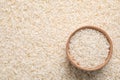 Pile of polished rice and wooden bowl. Space for text