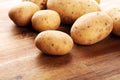 Pile of potatoes lying on wooden boards. Fresh healthy potato