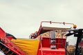 Pile of potatoes on trailer with vintage tractor