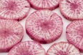 Pile of purple daikon radish slice isolated on white background