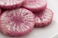 Pile of purple daikon radish slice isolated on white background