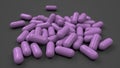 Pile of purple medicine capsules