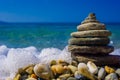 Pile of pyramid shaped pebbles. Waves is hitting the stones. Sea and beach background. Summer and holiday concept. Izmir, Turkey Royalty Free Stock Photo