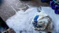 A pile of rags, in the middle of a white detergent foam